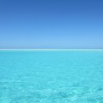 Crystal-clear turquoise ocean under a bright blue sky.